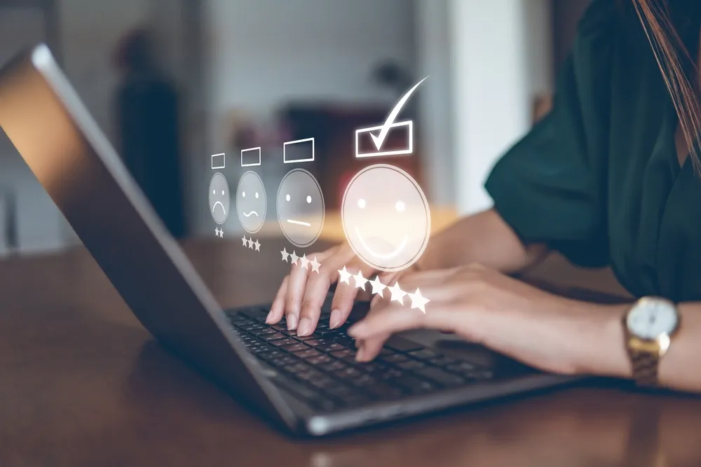 A female customer typing on her laptop as she leaves a review on a restaurant. Digital marketing for restaurants with Google Reviews and Yelp can show you how to effectively manage your online reputation.