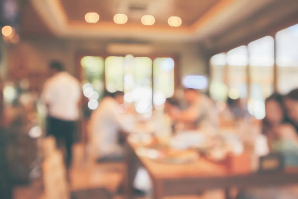 A blurred out photo of a restaurant interior. With email marketing, you can have a direct line of communication with your customers long after they've left the restaurant.
