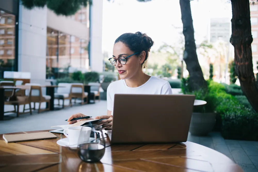 A restaurant owner working on a laptop as she considers which email marketing strategy is best for her restaurant