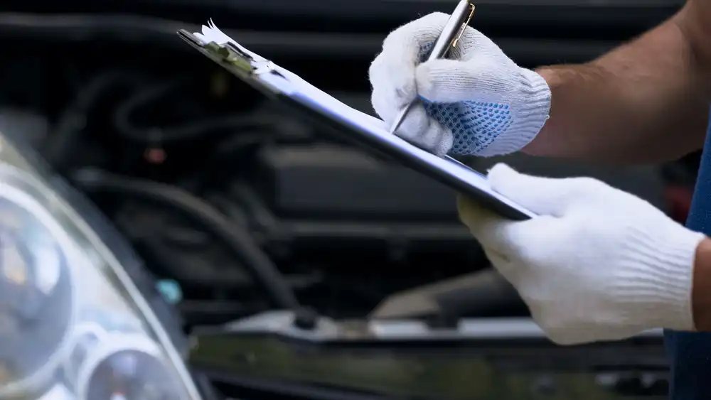 An inspector checking a food truck in Austin, TX - image of gloved hands and a clipboard