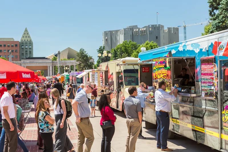 Hungry crowds of people waiting in line at a food truck festival in Denver, Colorado.