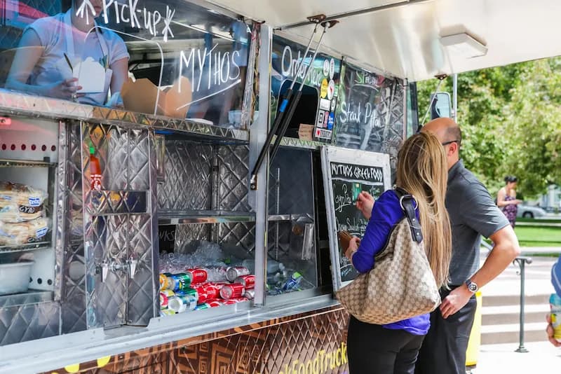 A couple on their lunch break at a food truck in Denver, Colorado.