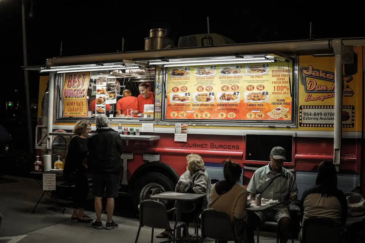 Elderly couple ordering from a food truck at night in Los Angeles