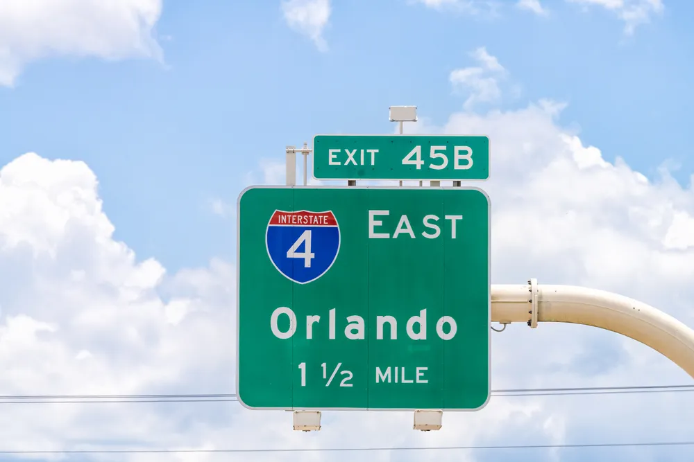 A freeway sign indicates the direction to Orlando, Florida. Orlando is where you can start a food truck business.