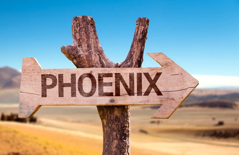 A wooden sign that says Phoenix. Phoenix is where you can start a food truck business.