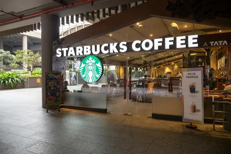 Exterior of a Starbucks store with the iconic green siren logo on the sign. Starbucks is a global coffeehouse chain known for its specialty coffee drinks, but more importantly for us, has many lessons to teach restaurant owners about building a successful business.