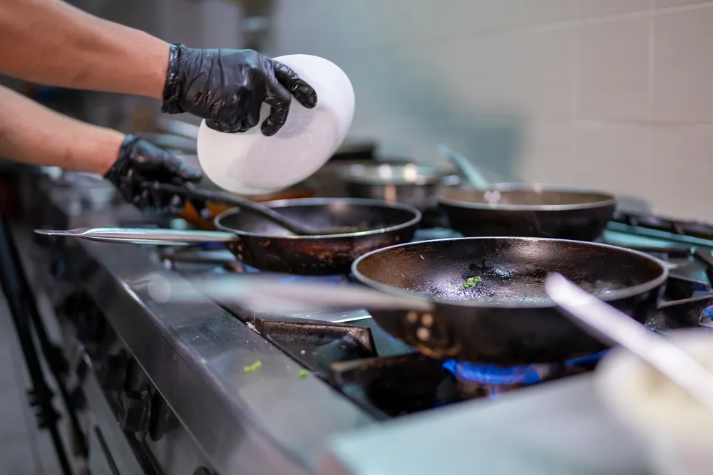 A commercial kitchen stove and oven range made of stainless steel. Buying used commercial kitchen equipment like this stove can save you money when opening a new restaurant.