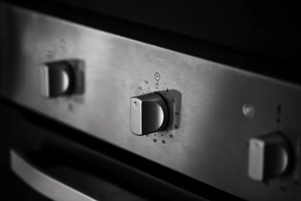 Close-up of the dials on a used commercial stove in a restaurant kitchen. Buying used restaurant equipment can save you thousands of dollars when opening a new restaurant.