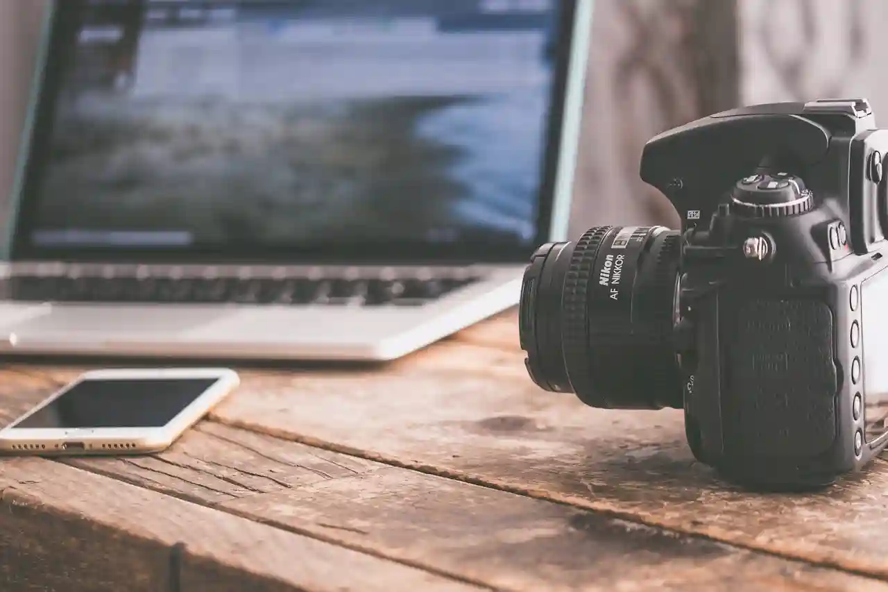 From culinary school to food writing... culinary school has benefits over learning on the job. Image of laptop, cell phone, and camera on a wooden table