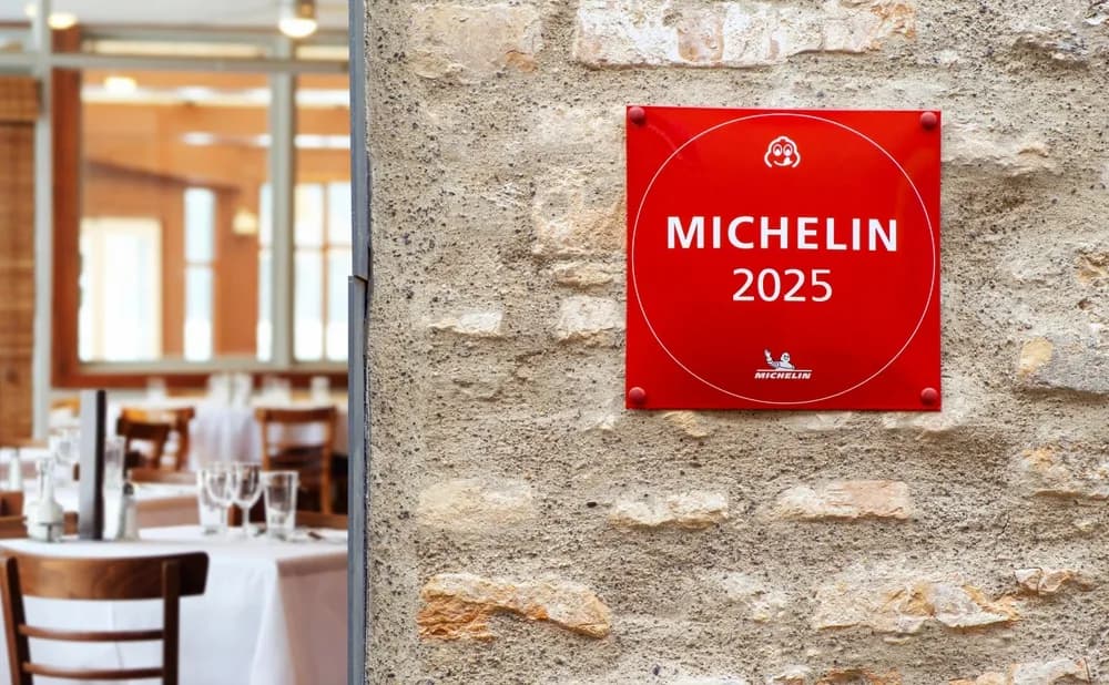 The exterior of a restaurant with its Michelin recognition displayed prominently at eye level.