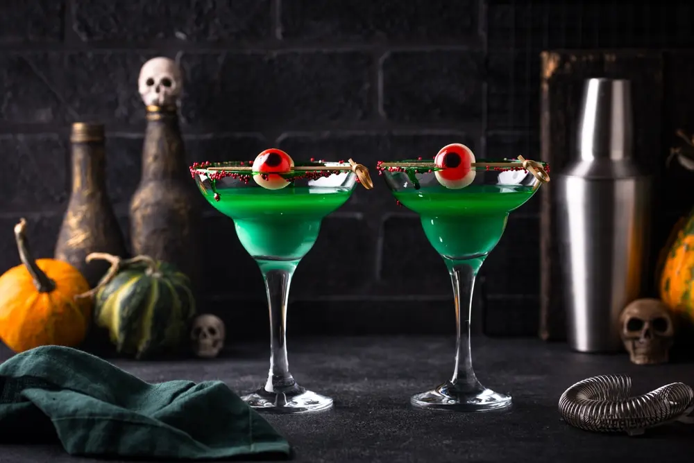 A successful mixology program requires more than just mixing drinks. It requires a good taste for flavors, knowledge of spirits and ingredients, and the right techniques. As shown in this image of a mixologist's take on a halloween cocktail with sour apple flavoring and a spooky garnish.