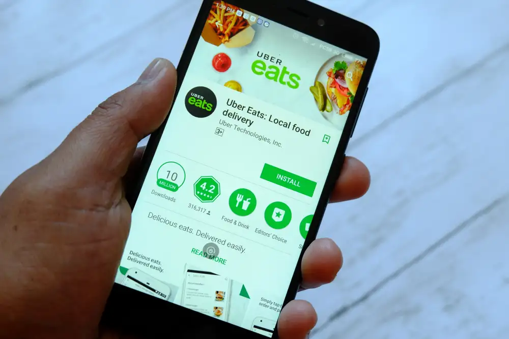 The food delivery app Uber Eats makes the top of the list of what is the best food delivery app for a restaurant in Europe. As shown in this image of the Uber Eats food delivery app being loaded on a smartphone in London, UK.