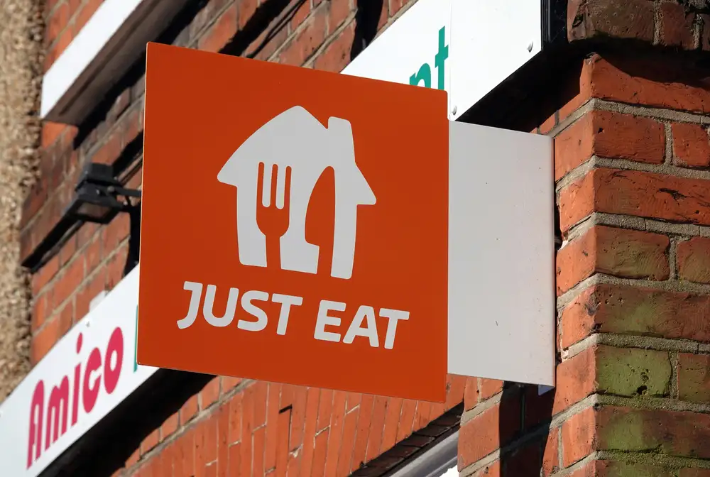 Just Eat is one of the best food delivery apps for a restaurant in Europe. As shown in this image of a Just Eat sign hanging on a restaurant in London.