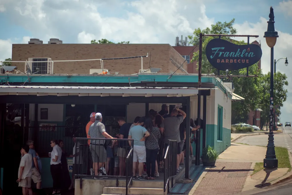The Franklin Barbecue restaurant with its iconic smoked brisket. Franklin Barbecue is a legendary Texas barbecue institution known for its mouth-watering smoked brisket and long lines of eager customers.