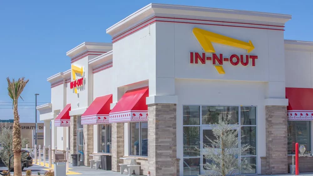 The In-N-Out Burger restaurant with its iconic red and yellow logo. In-N-Out is a popular fast-food chain known for its fresh ingredients and secret menu.