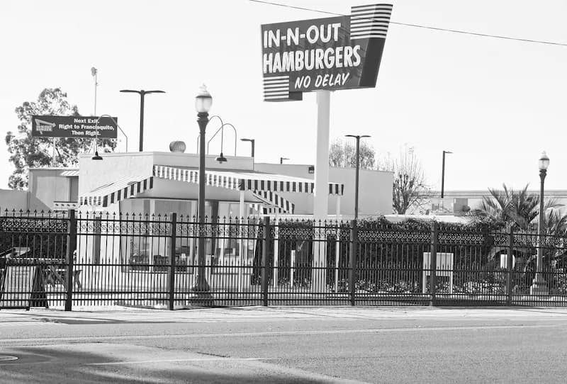 A black and white photo of a replica of the original In-N-Out Burger stand located in Baldwin Park, California.