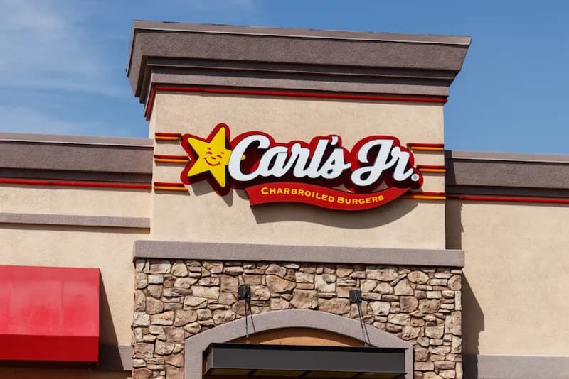 Exterior view of a Carl's Jr. restaurant. The familiar Carl's Jr. logo history and branding have become iconic in the fast food industry.